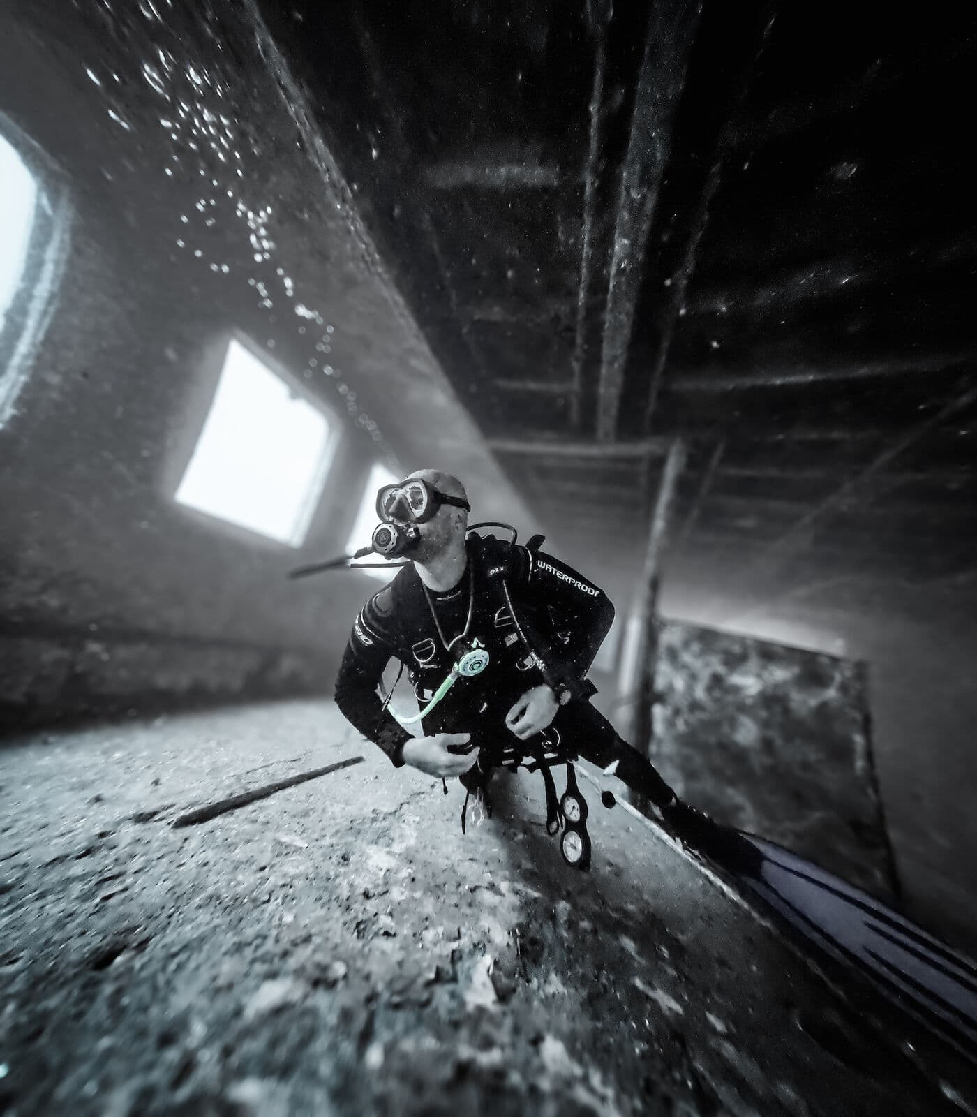 A diver gliding inside a wreck in Kaş